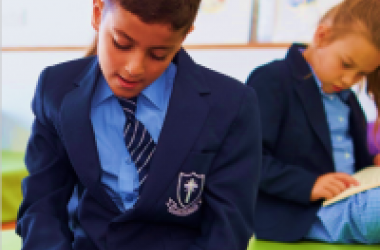 School child reading book